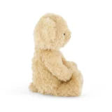 Beige Fluffy Stuffed Bunny Sitting Upright Viewed from the Side