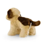 Back View of a Beige and Brown Plush Dog Toy Standing on a White Surface with a Small Tag Attached to Its Side
