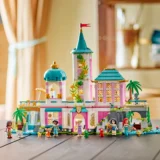 Colorful Lego Friends Castle Playset with Pink and Teal Towers Palm Trees and Minifigure Characters Lined Up in Front