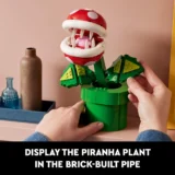 Brick built Piranha Plant Emerging from a Green Pipe Hands Adjusting the Model Tutorial Thumbnail with a Bold Caption at Bottom