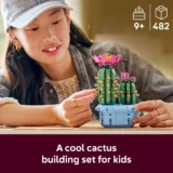 Girl Building a Cactus themed Lego Set with Pink Flowers on a Blue Pot Product for Ages 9+ with 482 Pieces hands and Face Visible