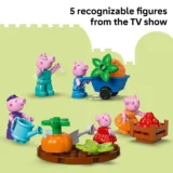 Five Peppa Pig Toy Figures in a Garden Playset with a Wheelbarrow of Produce on a Pale Green Backdrop