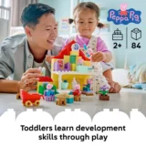 Father and Young Girl Playing with a Colorful Peppa Pig Building Set on a Table with Figures informational