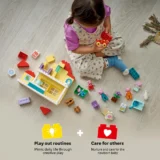 Child Sits on a Light Floor Building a Colorful Lego House with Scattered Blocks and Figures Nearby