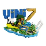 Colorful Lego Water park Scene with a Minifigure Kicking a Blue Water Jet Toward a Ball Set on a Green Base with Blue Water Edging