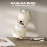 Cream colored Insulated Bottle Tilted on a Desk Featuring a Cute Logo and the Headline 'secure Seal Design' with the Subtext 'built to Prevent Leaks Even on the Go' Visible Above the Bottle