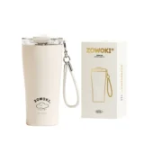 Cream colored Insulated Tumbler with a White Wrist Strap Shown Beside Its Zowoki Box