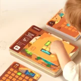 Child Playing a Colorful Board Game Placing a Tile on a Card filled Table with a 'digging Mole' Box and Stacked Tiles Nearby