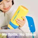 Smiling Child Holds a Large Yellow Choko Labo Bottle with a Blue Base Preparing to Place It in a Bag