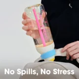 Clear Spillproof Water Bottle with a Pink Straw Held over a Light Backpack Bottom Text Reads 'no Spills No Stress'