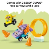 Duplo Race Car Set with Two Colorful Cars Orange Cones and a Yellow Loop Against a Pale Green Background