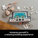Partial Lego Pool Build on a Desk with Scattered Bricks Bowls of Pieces and a Black Base Frame Around a Blue twater Mosaic Scene