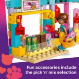 Colorful Lego Candy Shop Scene with a Figure Picking a Pink Scoop from a Glass Counter Filled with Chocolates and Treats