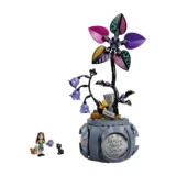 Lego Deadly Nightshade Playset a Tall Black Stem with Multicolored Petals on a Gray Base Plus a Girl Minifigure and a Black Cat Nearby text 'deadly Night Shade' on the Pedestal