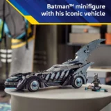 Lego Batman Batmobile with Large Winged Fins on a Round Table Batman Minifigure Nearby in a Display Setup