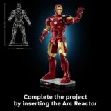 Lego Iron Man Statue in Red and Gold on a Base Blueprint Outline on the Left and the Caption 'complete the Project by Inserting the Arc Reactor'